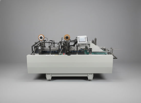 Front view of a grey industrial automatic double-sided tape applicator with dual heads and a touchscreen control panel.