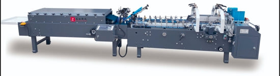 High-precision automatic folder-gluer machine in a clean industrial setting, showing the feeding, folding, and gluing modules