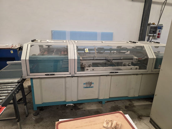Front view of the CMC 70x100 laminating machine with clear safety covers and internal mechanisms visible.