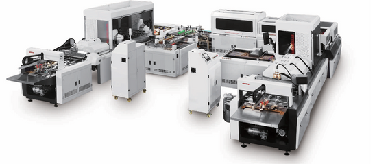 Full view of the JDS QFM 460/600 automatic hardcover case production line, showing multiple white and grey machinery units co