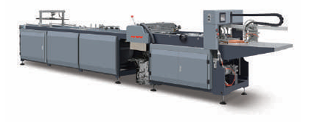 Long industrial automatic gluing machine with feeder and output section on a white background