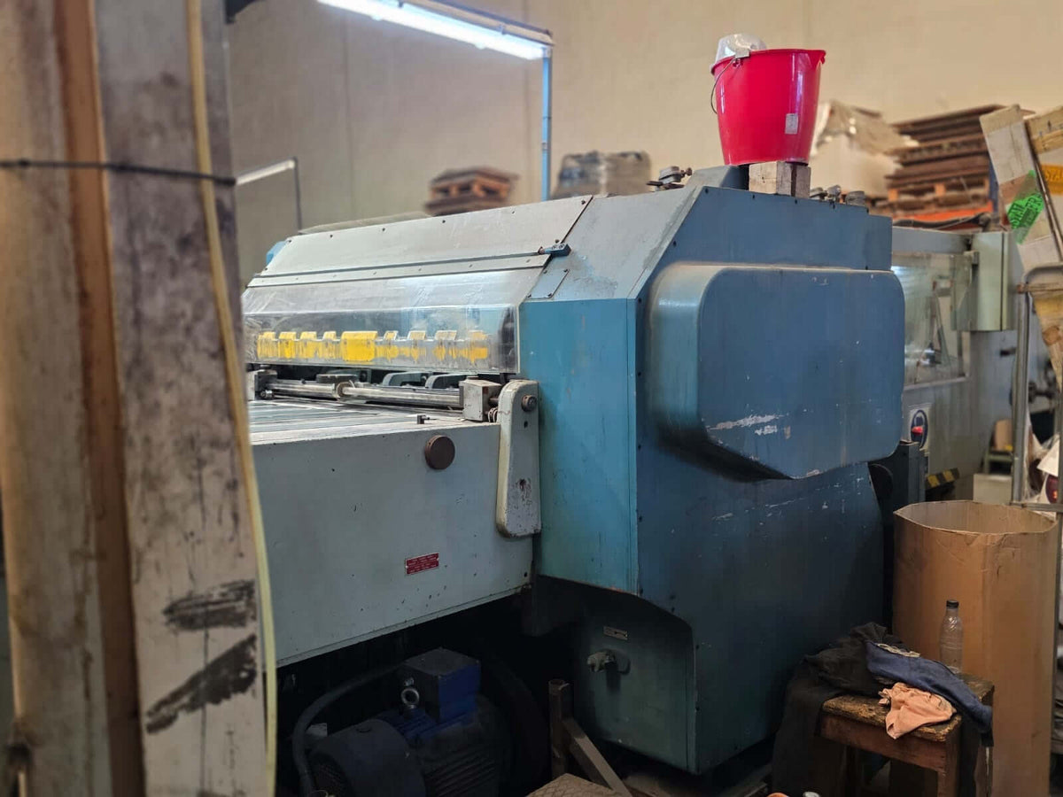 Iberica DG 60F automatic die-cutting machine in an industrial workshop, showing its robust blue frame and operational area.